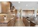 Contemporary kitchen with wooden cabinets, island, stainless steel appliances, and designer tile backsplash at 16371 Jones Mountain Way, Broomfield, CO 80023