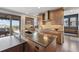 Modern kitchen boasts wooden cabinetry, large center island, and stainless steel appliances at 16371 Jones Mountain Way, Broomfield, CO 80023