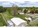 Overhead view of property featuring outbuildings, mature trees, a well-kept lawn, and a perimeter fence at 3784 Whitetail Ct, Mead, CO 80542