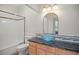 Bathroom with granite vanity, tiled shower, and glass vessel sink at 3784 Whitetail Ct, Mead, CO 80542