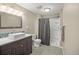 Modern bathroom featuring a vessel sink, wood vanity, and shower with gray curtain at 3784 Whitetail Ct, Mead, CO 80542