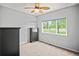 Bright bedroom featuring a ceiling fan and a window with views of the green lawn at 3784 Whitetail Ct, Mead, CO 80542