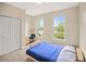 Bedroom featuring a light wood bedframe, neutral carpet, two large windows and closet at 3784 Whitetail Ct, Mead, CO 80542