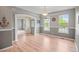 Well-lit dining room features beautiful hardwood floors, decorative wainscoting and stylish light fixtures at 3784 Whitetail Ct, Mead, CO 80542