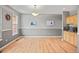 Bright dining room with hardwood floors, gray walls, wainscoting, and custom cabinets at 3784 Whitetail Ct, Mead, CO 80542