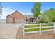 Brick home with double garage and white fence at 3784 Whitetail Ct, Mead, CO 80542