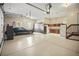 Spacious garage with car, built-in storage cabinets, and staircase at 3784 Whitetail Ct, Mead, CO 80542