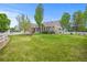 House exterior featuring brick and siding, large yard, and white fence at 3784 Whitetail Ct, Mead, CO 80542