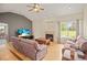 Cozy living room featuring a fireplace, hardwood floors, and large windows with views of the outdoors at 3784 Whitetail Ct, Mead, CO 80542