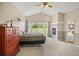 Serene main bedroom with a fireplace, large windows, and access to a luxurious en-suite bathroom at 3784 Whitetail Ct, Mead, CO 80542