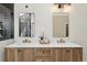 Bright bathroom features a double vanity, stylish lighting, and neutral paint at 7309 Windsor Dr, Boulder, CO 80301