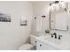 Powder room featuring modern fixtures, a stylish mirror, and a clean design for a fresh feel at 7309 Windsor Dr, Boulder, CO 80301