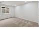 Well-lit bedroom featuring neutral carpet, a window, and ample space at 7309 Windsor Dr, Boulder, CO 80301
