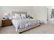 Bright bedroom featuring a queen bed with stylish linen and a wooden nightstand at 7309 Windsor Dr, Boulder, CO 80301