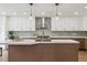 Beautiful kitchen with white cabinets, a large island, stainless steel appliances, and stylish pendant lighting at 7309 Windsor Dr, Boulder, CO 80301