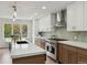 Bright kitchen featuring two-tone cabinets, stainless steel appliances, a large island and backyard views at 7309 Windsor Dr, Boulder, CO 80301