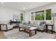 Bright living room featuring a large window, comfortable seating, stylish decor and a neutral color palette at 7309 Windsor Dr, Boulder, CO 80301