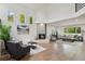 Open-concept living room boasts fireplace, hardwood floors, and natural light from large windows at 7309 Windsor Dr, Boulder, CO 80301