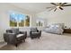 Spacious main bedroom with a ceiling fan, ample natural light, and comfortable seating area at 7309 Windsor Dr, Boulder, CO 80301