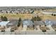 Aerial view of homes in a neighborhood with a golf course and small lake in the background at 664 Clarendon Dr, Longmont, CO 80504