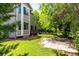 Large backyard with patio, lush lawn, mature trees, and beautiful landscaping, ideal for outdoor at 664 Clarendon Dr, Longmont, CO 80504