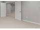Finished basement with neutral colored walls and floors, and white doors and trim at 664 Clarendon Dr, Longmont, CO 80504