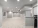 Spacious basement with carpet, recessed lighting, and neutral colors creating a bright living space at 664 Clarendon Dr, Longmont, CO 80504