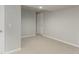 Finished basement with neutral colored walls and floors, and white doors and trim at 664 Clarendon Dr, Longmont, CO 80504