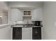 Basement kitchenette with gray counters and black mini-refrigerator at 664 Clarendon Dr, Longmont, CO 80504