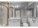 Bathroom featuring a glass shower and vanity with modern fixtures and lighting at 664 Clarendon Dr, Longmont, CO 80504