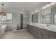 Stylish bathroom featuring double vanity, frameless glass shower, soaking tub, and modern finishes at 664 Clarendon Dr, Longmont, CO 80504