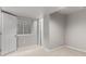 Clean basement bedroom with egress window, neutral carpet and paint, and a nearby doorway at 664 Clarendon Dr, Longmont, CO 80504