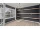 Dining room featuring modern light fixtures, wood floors, and large window at 664 Clarendon Dr, Longmont, CO 80504