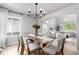 Elegant dining room featuring a modern chandelier, a large dining table, and neutral decor at 664 Clarendon Dr, Longmont, CO 80504