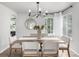 Bright dining room with a modern chandelier, a wooden dining table, and views of the outdoors at 664 Clarendon Dr, Longmont, CO 80504
