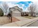 Beautiful home exterior with a two-car garage, fenced yard and a paved driveway at 664 Clarendon Dr, Longmont, CO 80504