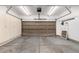 Spacious garage with storage cabinets and a large overhead door, offering ample room for parking at 664 Clarendon Dr, Longmont, CO 80504