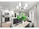 Eat-in kitchen with an island featuring stone countertops, stainless steel appliances, and view to living room at 664 Clarendon Dr, Longmont, CO 80504