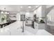 Bright, open kitchen featuring a large island, stone countertops, and stainless steel appliances at 664 Clarendon Dr, Longmont, CO 80504