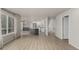 Open kitchen and dining area features modern appliances, large windows, and access to outdoor deck at 664 Clarendon Dr, Longmont, CO 80504