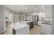 Kitchen features an island with breakfast bar, stainless appliances, and views of backyard at 664 Clarendon Dr, Longmont, CO 80504