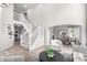 Open-concept living area with a staircase, neutral decor, and views into the dining room at 664 Clarendon Dr, Longmont, CO 80504