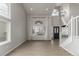 Bright living area with a vaulted ceiling, large windows, and modern floors and staircase at 664 Clarendon Dr, Longmont, CO 80504