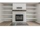 Close-up of a modern fireplace with a decorative hearth and built-in shelving at 664 Clarendon Dr, Longmont, CO 80504