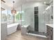 This light and bright main bathroom features a freestanding tub, walk-in shower, and modern fixtures at 664 Clarendon Dr, Longmont, CO 80504