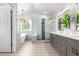 Bright, modern bathroom with a glass shower, freestanding tub and dual sinks at 664 Clarendon Dr, Longmont, CO 80504