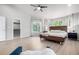 Bright main bedroom with wood floors, lots of windows, a platform bed and a walk-in closet at 664 Clarendon Dr, Longmont, CO 80504