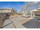 Large backyard features a spacious deck, mature tree and a privacy fence at 7867 S Poplar Way, Centennial, CO 80112