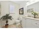 Well-lit half bathroom with a large mirror, tile floors, and neutral paint at 7867 S Poplar Way, Centennial, CO 80112