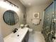 Well-lit bathroom with modern fixtures, decorative mirror, and patterned shower curtain at 7867 S Poplar Way, Centennial, CO 80112